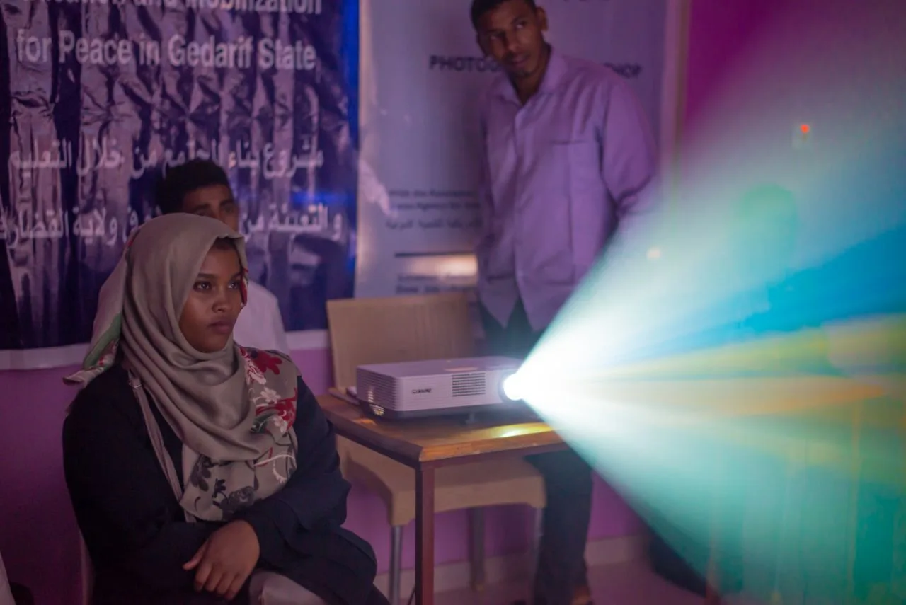 A participant watching a projected presentation in a workshop