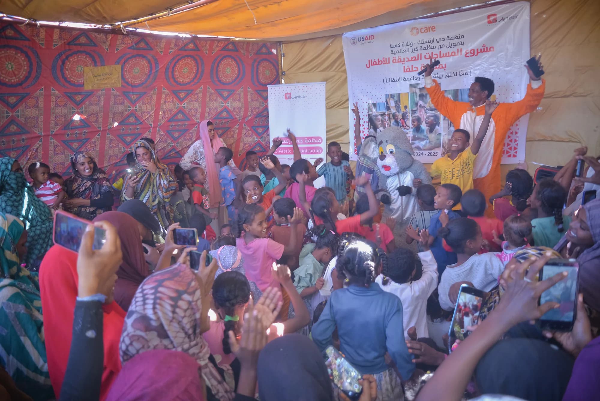 A large community gathering at a child-friendly event.